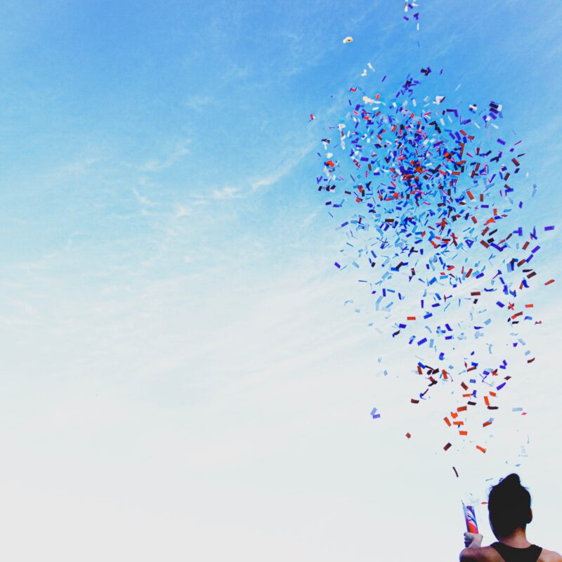 woman celebrating by opening a confetti cannon