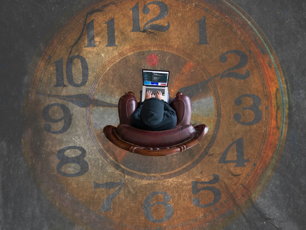 a person outsourcing life admin while sat at a laptop over a picture of a clock